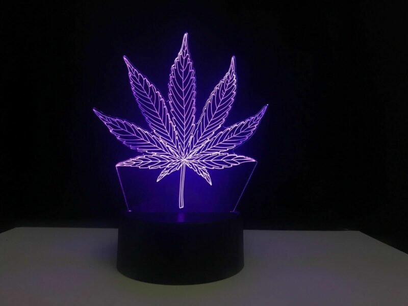 Person with weed night light Australia Clear acrylic color, front view, showing 3D weed design.