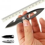 Person with camping knife Australia Black color, front view, showing 5cm blade.