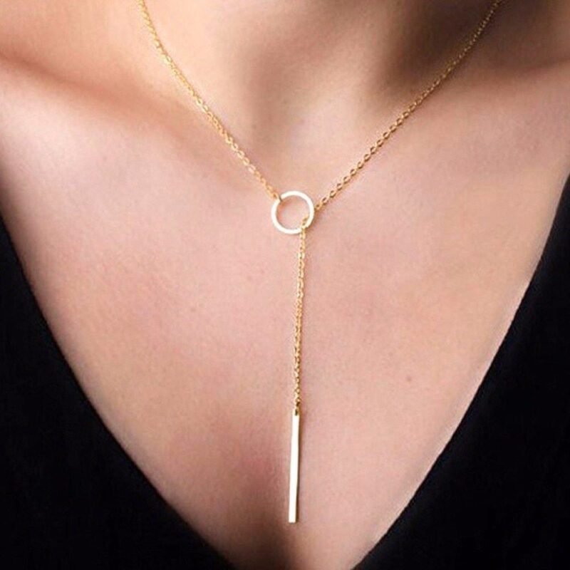 Person with lariat necklace Australia Gold color, front view, showing bar circle pendant.