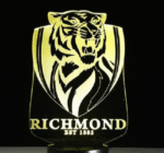 Person with Richmond Tigers night light Australia Clear acrylic color, front view, showing 3D logo.
