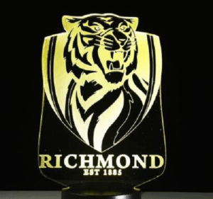 Person with Richmond Tigers night light Australia Clear acrylic color, front view, showing 3D logo.