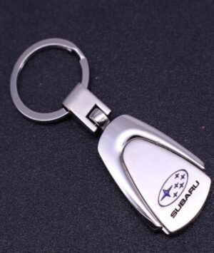 Titanium Subaru car emblem keyring with ring logo on a white background.