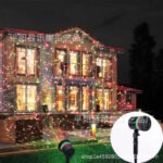Outdoor Christmas LED projector casting red and green stars on a garden.