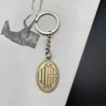 A bronze zinc alloy keychain with AC Milan logo.
