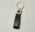 A black and silver leather keychain with Mercedes Benz logo.