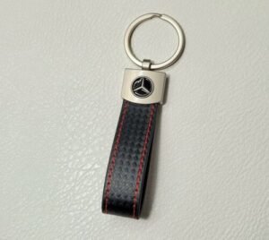 A black and silver leather keychain with Mercedes Benz logo.