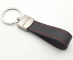 Black leather AMG Mercedes keyring with carbon effect and logo.