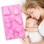 Pink baby birthday silicone mold with bear and footprint design for cake decorating.