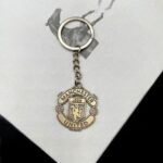 A bronze zinc alloy keychain with Manchester United logo.