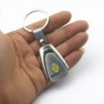 Renault titanium keychain Australia with car logo on a white background.