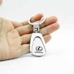 Lexus titanium keychain Australia with car logo on a white background.