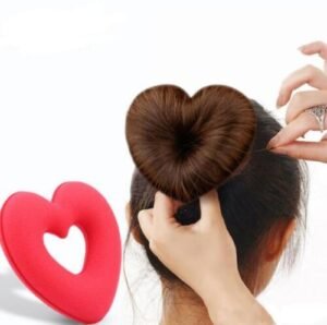 A heart shape tiaras hair tool shaping a girl’s bun.