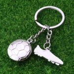 Silver soccer shoes keychain with creative metal trinket design.