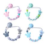 Blue koala silicone pacifier clip attached to a baby’s shirt.