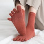 Grey solid color toe socks Australia on a woman’s feet during a walk.