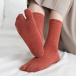 Black solid color split-toe socks Australia on a woman’s feet during a walk.