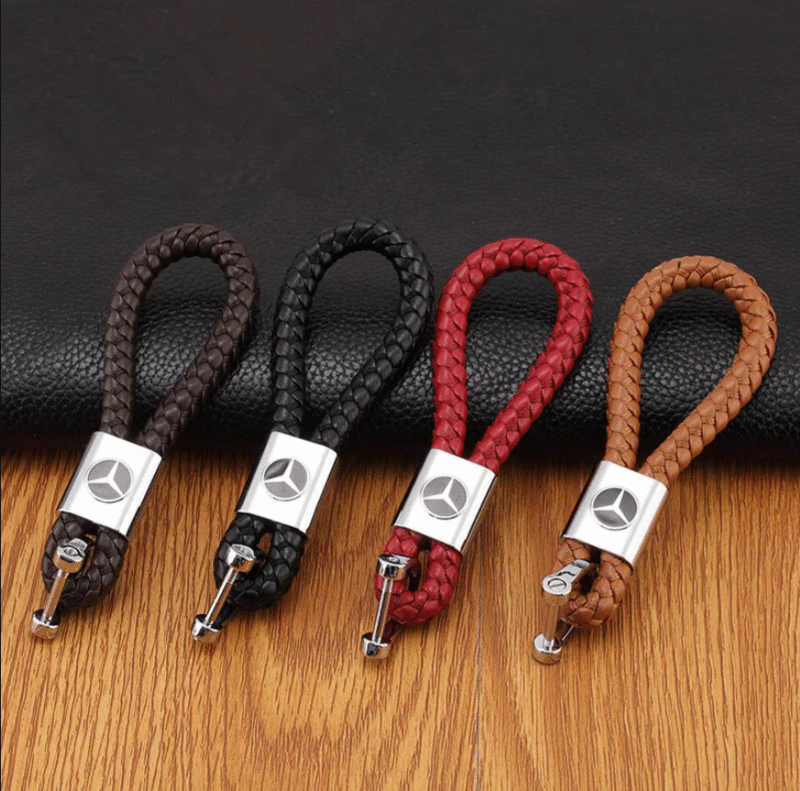 A shiny black PU leather keychain with a Mercedes Benz logo.