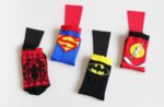 Colourful kids cotton socks with Spiderman design, worn by a child playing.
