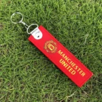 Real Madrid football keychain Australia with team logo on a gold keychain.