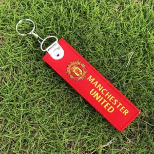 Real Madrid football keychain Australia with team logo on a gold keychain.