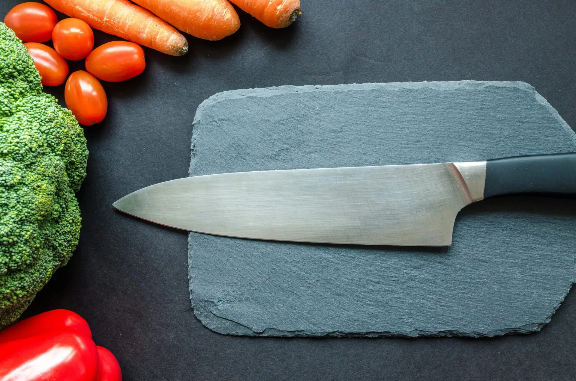 - Collection of high quality kitchen utensils including silicone spatulas stainless steel whisks and specialty tools arranged on a wooden surface